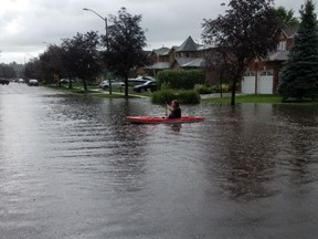 A kayaker takes advantage of the situation in Barrie on Tuesday.