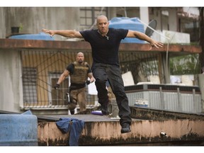 Luke Hobbs (Dwayne Johnson) chases after Dom Toretto (Vin Diesel) in a scene from Fast Five.