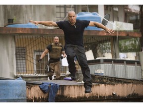 Luke Hobbs (Dwayne Johnson) chases Dom Toretto (Vin Diesel) in a scene from Fast Five.