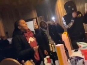 Niagara Regional Police detectives investigating a double murder are looking to identify the two people not wearing masks in this image from a party in Fort Erie on January 19, 2021.