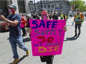 Several dozen protesters march through the Downtown Eastside of Vancouver, BC Tuesday, May 11, 2021 calling for a safe supply of street drugs.