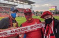 Brad Humber (centre), president of the fan support group Red Patch Boys, takes in the Toronto FC home game with fellow members Josh Glober (left) and Tom Rudan (right) at BMO Field on Saturday, July 17, 2021.