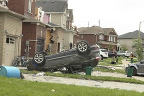 A tornado tore through a neighbourhood in the southeast end of Barrie on Thursday damaging at least 150 homes. A car is seen flipped on its roof on Majesty Blvd. on Friday July 16, 2021.