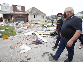 A day after a tornado ripped through a Barrie neighbourhood and damaged at least 150 homes, Ontario Premier Doug Ford surveys the damage with Barrie Police Chief Kimberley Greenwood while also taking time to speak to residents and first responders on Friday July 16, 2021.