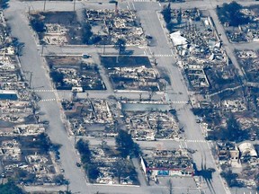 The charred remnants of homes and buildings, destroyed by a wildfire on June 30, are left behind in Lytton, July 6, 2021, as seen in this aerial photograph.