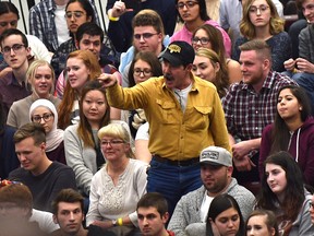 A man yells at Prime Minister Justin Trudeau as  he answers questions at his cross country town hall meeting at MacEwan University in Edmonton, Feb. 1, 2018.