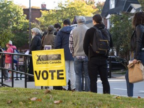 People line up to enter a polling station, in 2019, on election day  in Ottawa, Monday, Oct. 21, 2019. CP/Justin Tang