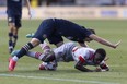 Philadelphia Union midfielder Deniel Gazdag falls onto Toronto FC midfielder Richie Laryea.