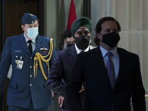 Immigration Minister Marco Mendicino, right, is joined by Harjit Sajjan, Minister of National Defence, second from right, as they arrive for a press conference in Ottawa on Friday, July 23, 2021.