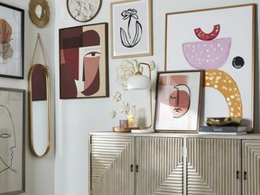 A gallery wall, anchored by a textural credenza from Homesense, is surrounded by a cluster of artworks, sourced from Winners and Marshalls, in various shapes and sizes. SUPPLIED