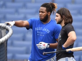 Vladimir Guerrero Jr.  and Bo Bichette of the Toronto Blue Jays talk things over during batting practice prior to Tuesday's game against at Nationals Park in Washington, D.C.