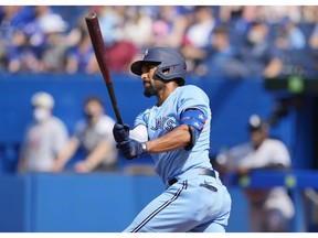 TORONTO, ONTARIO - AUGUST 26: Marcus Semien #10 of the Toronto Blue Jays hits a home run against the Chicago White Sox in the first inning during their MLB game at the Rogers Centre on August 26, 2021 in Toronto, Ontario, Canada.