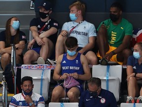 Tom Daley of Great Britain knits as he watches the Women's 3m Springboard Final on day nine of the Tokyo 2020 Olympic Games at Tokyo Aquatics Centre on August 01, 2021 in Tokyo, Japan.