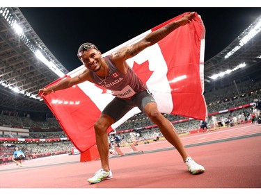 TOKYO, JAPAN - AUGUST 01: Andre De Grasse of Team Canada celebrates after winning the bronze medal in the Men's 100m Final on day nine of the Tokyo 2020 Olympic Games at Olympic Stadium on August 01, 2021 in Tokyo, Japan.