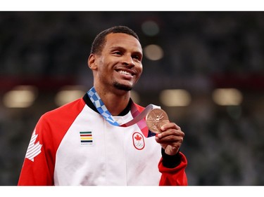 TOKYO, JAPAN - AUGUST 02:  Bronze medalist Andre De Grasse of Team Canada holds up his medal on the podium during the medal ceremony for the Men's 100m on day ten of the Tokyo 2020 Olympic Games at Olympic Stadium on August 02, 2021 in Tokyo, Japan.