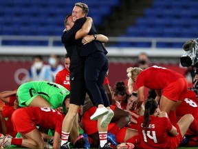 Head Coach of Team Canada Bev Priestman celebrates following her team's victory to win the gold medal during the Gold Medal Match Women's Football match between Canada and Sweden at the Olympics.