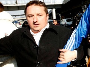 FILE PHOTO: Canadian businessman Michael Spavor arrives next to the former NBA basketball player Dennis Rodman (not pictured) after a trip to North Korea, at Beijing Capital International Airport on Jan. 13, 2014