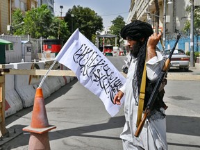 A Taliban fighter patrols along a street in Kabul on August 17, 2021, as the Taliban moved quickly to restart the Afghan capital following their stunning takeover of Kabul and told government staff to return to work.