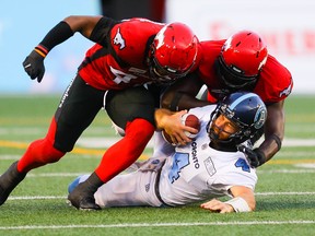Argonauts quarterback McLeod Bethel-Thompson, here being sacked Stamps' Wynton McManis and now teammate Cordarro Law in 2019, starts for the Boatmen again tonight with Nick Arbuckle still hurting from training camp.