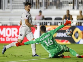 Inter Miami forward Robbie Robinson (left) shoots the ball over Toronto FC goalkeeper Quentin Westberg in Fort Lauderdale last night.