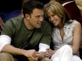 Ben Affleck gets a smile from girlfriend Jennifer Lopez  during the Los Angeles Lakers and San Antonio Spurs playoff game in Los Angeles, May 11, 2003.