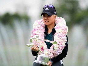 Danielle Kang of the U.S. poses with her trophy after winning the inaugural Shanghai LPGA golf tournament in Shanghai on October 21, 2018.