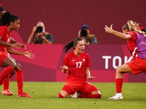 Canada's midfielder Jessie Fleming (C) celebrates with teammates after scoring the opening goal during the Tokyo 2020 Olympic Games women's semi-final football match between the United States and Canada at Ibaraki Kashima Stadium in Kashima on August 2, 2021.