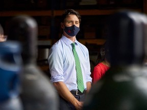 Prime Minister Justin Trudeau listens to protesters during a campaign event at VeriForm Inc. in Cambridge, Ontario, on August 29, 2021.