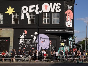 People arrive to undergo express PCR tests for Covid-19 outside the KiKat Club prior to taking part in an experimental, limited opening of Berlin nightclubs during the coronavirus pandemic on August 6, 2021 in Berlin.