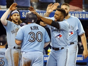 Teoscar Hernandez of the Toronto Blue Jays celebrates as Alejandro Kirk scores a run on a George Springer double against the Boston Red Sox at Rogers Centre on August 6, 2021.