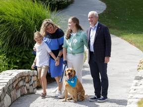 Leader of the Conservative Party of Canada Erin O'Toole, his wife Rebecca, daughter Mollie and son Jack stand with their dog Wexford during a campaign stop at Dog Tales Rescue and Sanctuary in King City, Ontario, August 30, 2021.