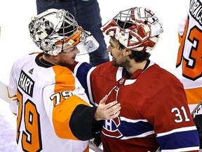 Carter Hart, left, of the Philadelphia Flyers shakes hands with Carey Price of the Montreal Canadiens after the Flyers 3-2 win in Game 6 of the Eastern Conference First Round during the NHL Stanley Cup Playoffs at Scotiabank Arena on Aug. 21, 2020 in Toronto.