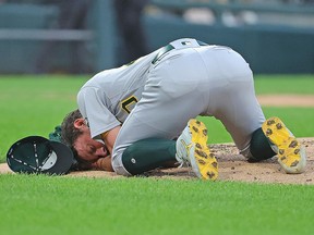 Pitcher Chris Bassitt of the Oakland Athletics lies on the ground after being hit in the head by a line drive from Brian Goodwin of the Chicago White Sox at Guaranteed Rate Field on August 17, 2021 in Chicago. 

in the second inning at Guaranteed Rate Field on August 17, 2021 in Chicago, Illinois. (Photo by Jonathan Daniel/Getty Images)