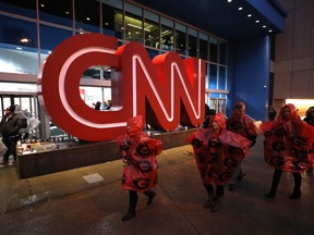Fans walk past the CNN Center en route to Mercedes-Benz Stadium on January 8, 2018 in Atlanta, Georgia.