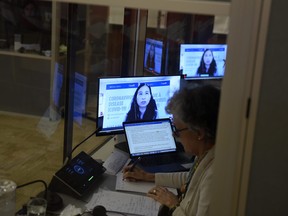 Chief Public Health Officer of Canada Dr. Theresa Tam is seen on a television in an interpretation booth as she appears at a news conference on the COVID-19 pandemic, in Ottawa, on Friday, June 4, 2021.
