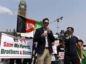 Dave Morrow, a Canadian Armed Forces veteran who served in Afghanistan, speaks during a rally calling on the Canadian government to evacuate the families of interpreters and locally employed civilians who supported the Canadian Armed Forces in Afghanistan as they are being targeted by the Taliban, on Parliament Hill in Ottawa, on Tuesday, Aug. 3, 2021.