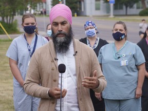 NDP Leader Jagmeet Singh responds to a question during a news conference surrounded by health-care workers in Edmonton, on Thursday, August 19, 2021.