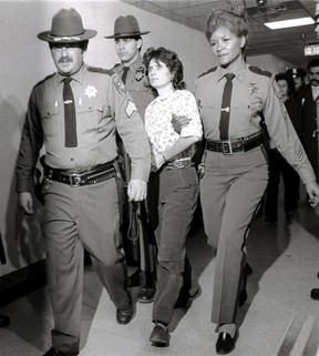In this Nov. October 21, 1981 photo. Weather Underground member Katherine Budin is escorted from the Rockland County Courthouse in New York, NY by sheriff's officers. (Handschuh/AP Photo)