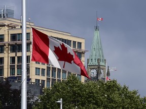 A Canadian flag flies at half-mast in Ottawa on Monday, June 28, 2021.
