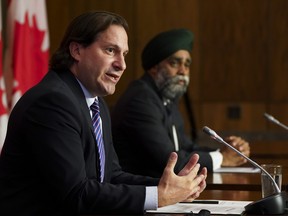 Immigration Minister Marco Mendicino, left, is joined by Harjit Sajjan, Minister of National Defence, at a press conference in Ottawa on Friday, July 23, 2021.