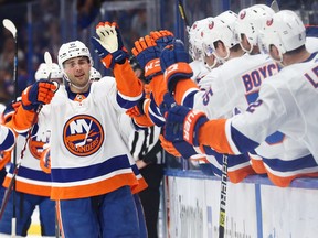 New York Islanders centre Derick Brassard is congratulated as he scores a goal against the Tampa Bay Lightning during the third period at Amalie Arena in Tampa, Fla., Feb. 6, 2020.