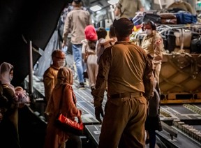 Canadian Forces personnel deplane people and cargo from an RCAF C-17 Globemaster at Toronto Pearson International Airport on Wednesday, carrying Afghan nationals in danger for helping Canada’s mission in Afghanistan