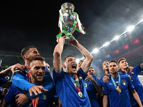 Leonardo Spinazzola, Rafael Toloi, Andrea Belotti and Jorginho of Italy celebrate with The Henri Delaunay Trophy following their team's victory in the UEFA Euro 2020 final at Wembley Stadium on July 11, 2021 in London.