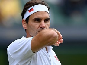In this file photo taken on July 7, 2021, Switzerland's Roger Federer plays against Poland's Hubert Hurkacz during their men's quarter-finals match on the ninth day of the 2021 Wimbledon Championships at The All England Tennis Club in Wimbledon, southwest London.
