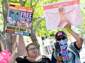 Fans and supporters of Britney Spears hold "Free Britney" signs as they gather outside the Los Angeles County Courthouse during a scheduled hearing in the Britney Spears guardianship case, in Los Angeles, July 19, 2021.