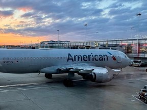 An American Airlines plane is seen at sunrise parked on the tarmac of the Reagan Washington National Airport (DCA) in Arlington, Virginia, on April 22, 2021.