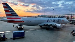 An American Airlines plane is seen at sunrise parked on the tarmac of the Reagan Washington National Airport (DCA) in Arlington, Virginia, on April 22, 2021.