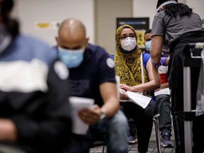 Talath Shams receives her COVID-19 vaccine inside the International Conference Center during the Peel Region's "Dose after dark" overnight vaccination clinic in Mississauga on May 15, 2021.