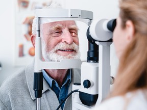 An elderly patient has his eyes checked.