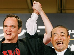US movie director Quentin Tarantino shares a light moment with Japanese actor Shinichi Chiba during a press conference to promote his new film "Death Proof" in Tokyo, 02 August 2007.